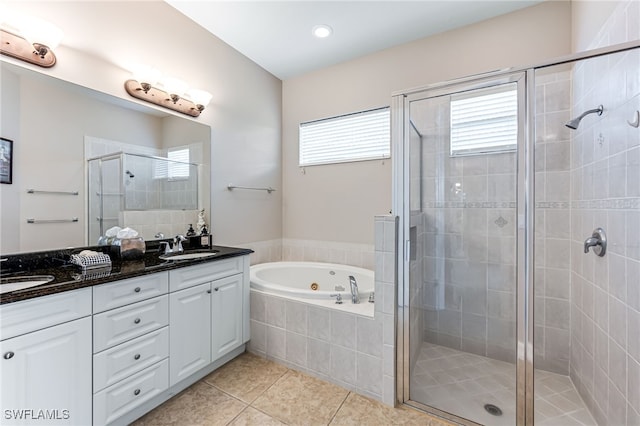 bathroom featuring tile patterned floors, vanity, and shower with separate bathtub