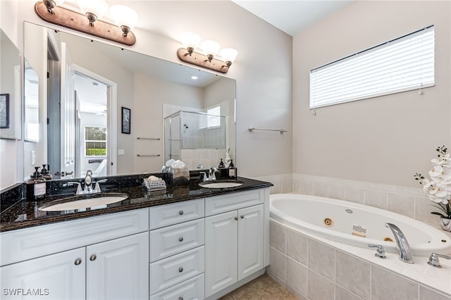 bathroom with vanity and independent shower and bath