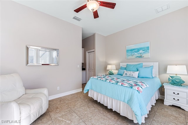 tiled bedroom with ceiling fan and a closet