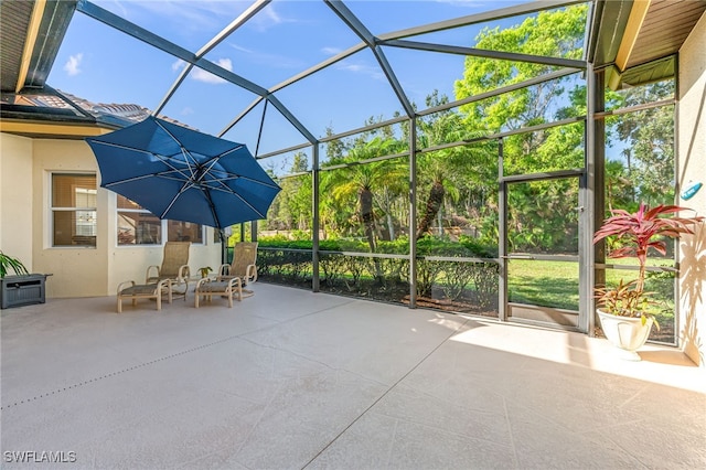 view of patio with glass enclosure