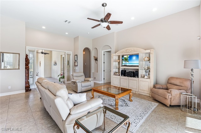 tiled living room with ceiling fan