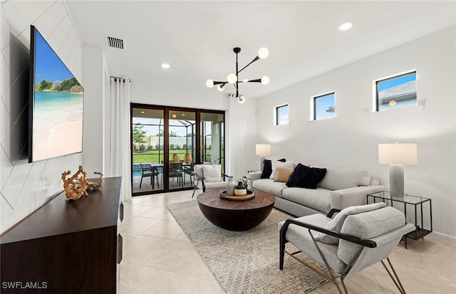 tiled living room featuring an inviting chandelier