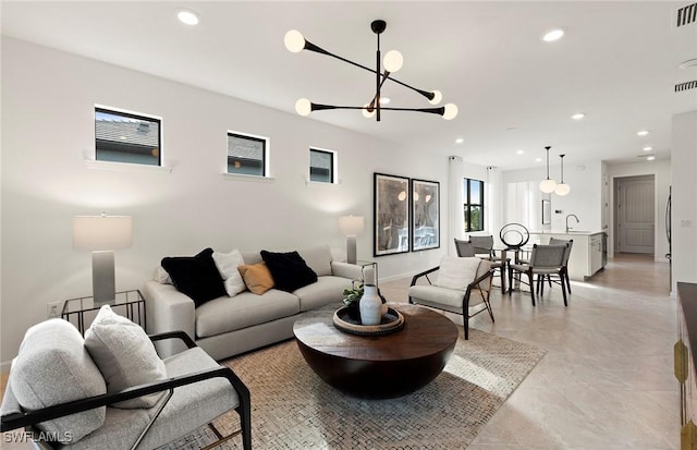 living room with sink and an inviting chandelier