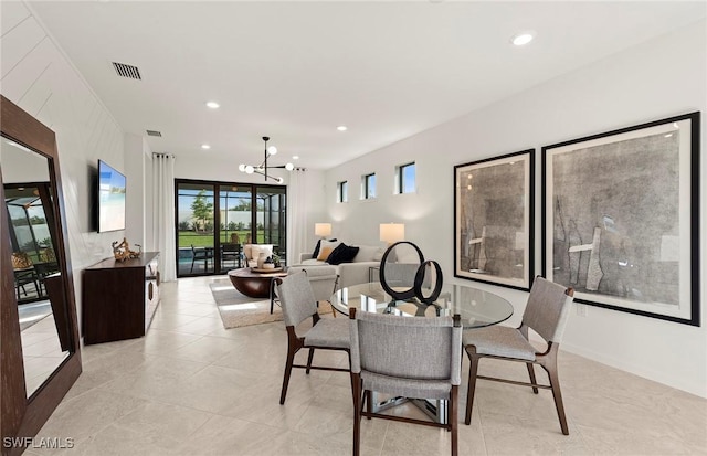 dining space with an inviting chandelier