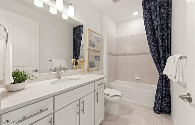 full bathroom featuring toilet, shower / bathtub combination with curtain, and vanity