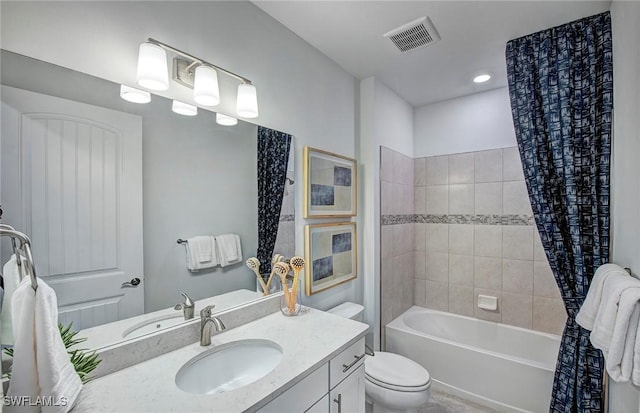 full bathroom featuring shower / bath combo with shower curtain, toilet, and vanity