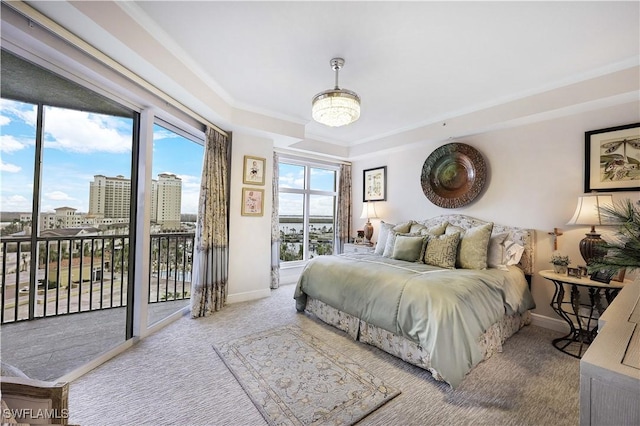 carpeted bedroom with ornamental molding and access to outside