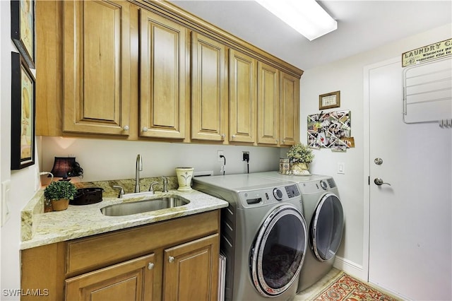 clothes washing area with cabinets, separate washer and dryer, and sink