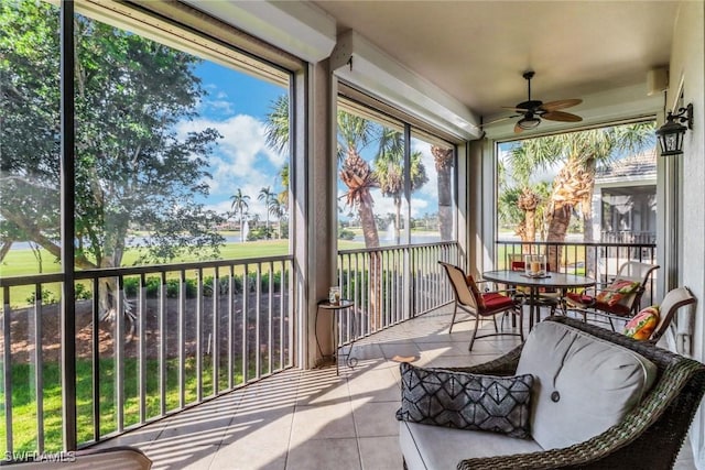 sunroom / solarium featuring ceiling fan