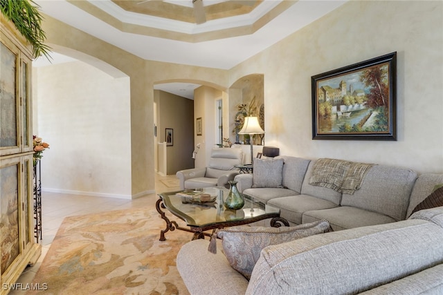 living room with crown molding and a raised ceiling