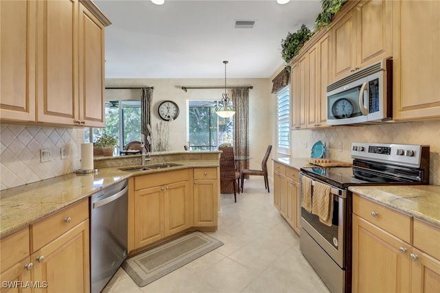 kitchen with decorative light fixtures, sink, light brown cabinets, and stainless steel appliances