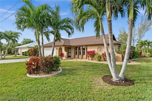 ranch-style home featuring a front yard and a garage