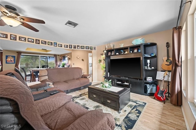 living room with ceiling fan and light hardwood / wood-style flooring