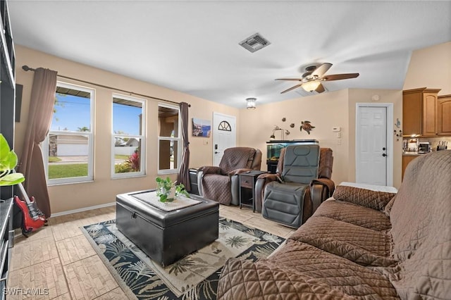 living room featuring ceiling fan and light hardwood / wood-style floors