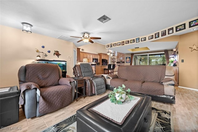 living room featuring ceiling fan and light wood-type flooring