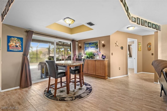 dining room featuring a tray ceiling