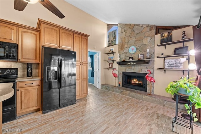 kitchen featuring black appliances, a fireplace, tasteful backsplash, vaulted ceiling, and ceiling fan