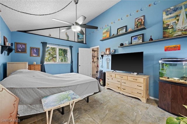 bedroom featuring ceiling fan, a textured ceiling, and vaulted ceiling