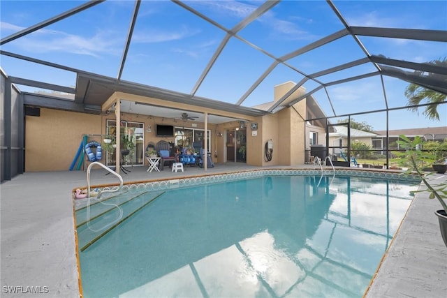 view of pool featuring a lanai, ceiling fan, and a patio