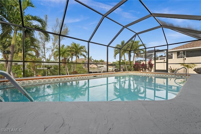 view of swimming pool featuring glass enclosure