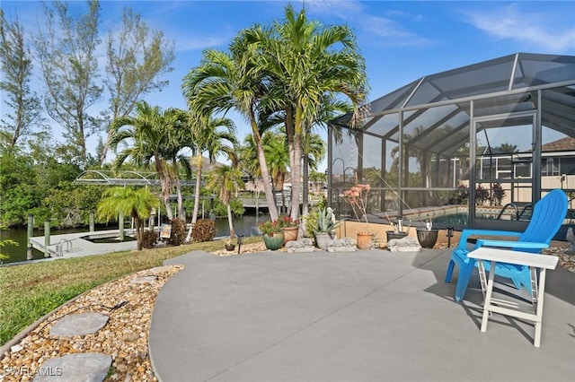 view of patio / terrace with a lanai and a water view