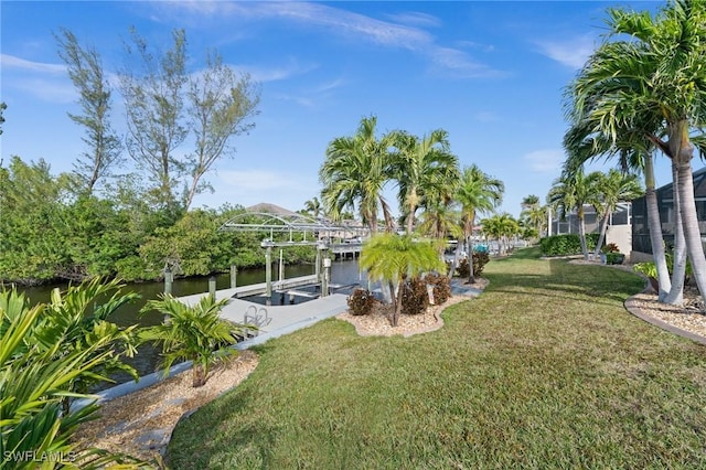 view of yard with a water view and a boat dock