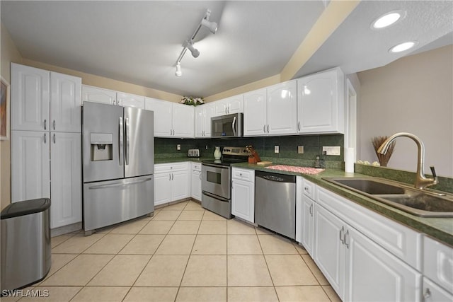 kitchen with sink, white cabinetry, and stainless steel appliances