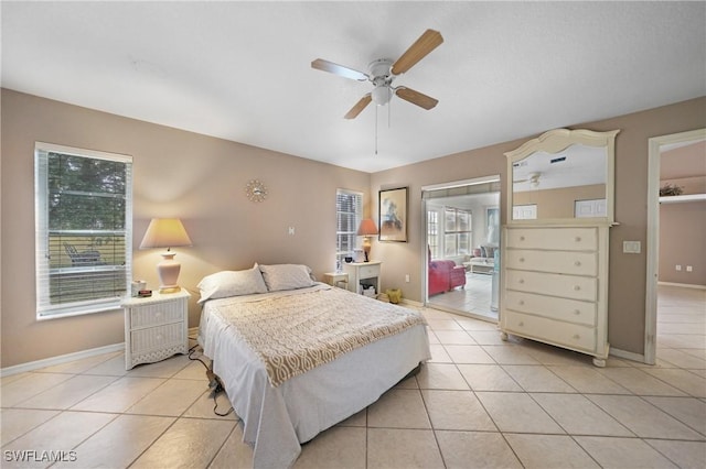 tiled bedroom featuring multiple windows and ceiling fan