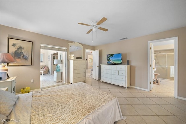 tiled bedroom featuring ensuite bathroom and ceiling fan