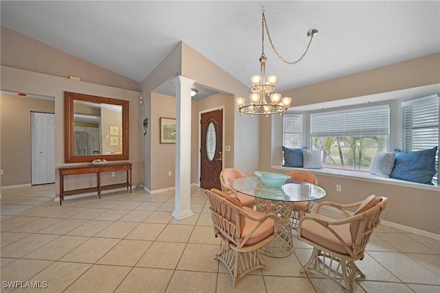 dining space with light tile patterned floors, vaulted ceiling, a notable chandelier, and ornate columns