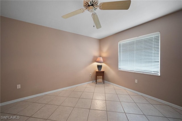 tiled spare room featuring ceiling fan