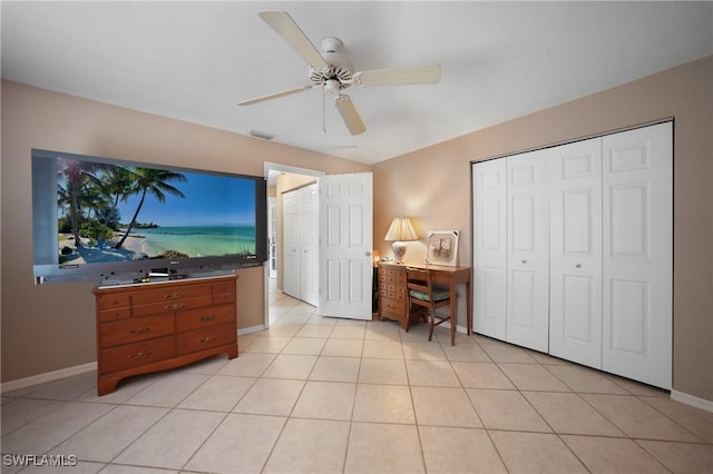 bedroom featuring ceiling fan, a closet, and light tile patterned flooring