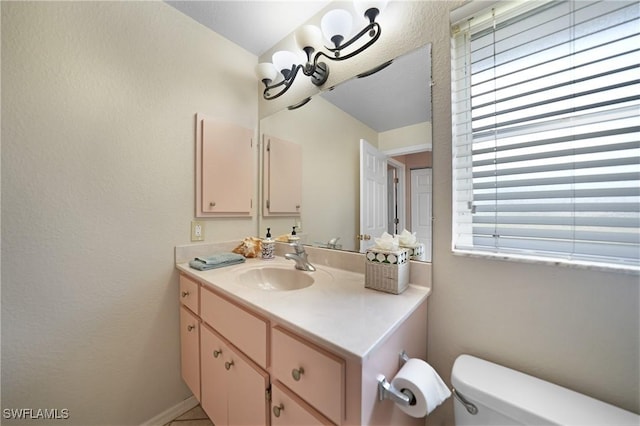 bathroom with toilet and vanity