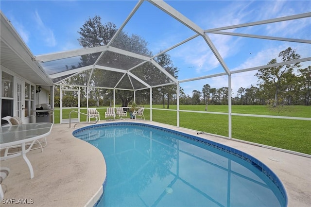 view of pool featuring glass enclosure, a patio area, a grill, and a yard