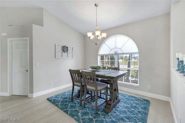 dining room with vaulted ceiling, light hardwood / wood-style flooring, and a notable chandelier