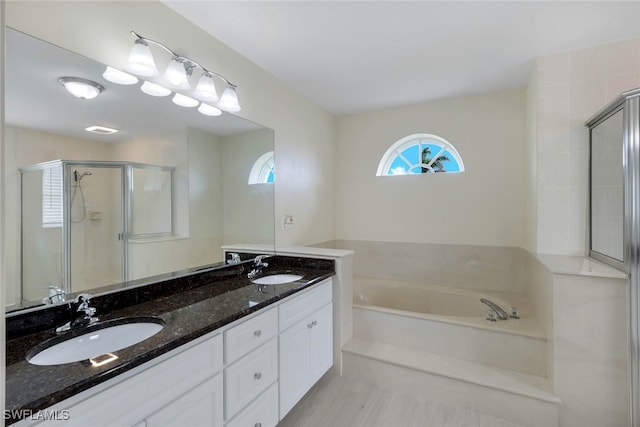 bathroom with vanity and separate shower and tub