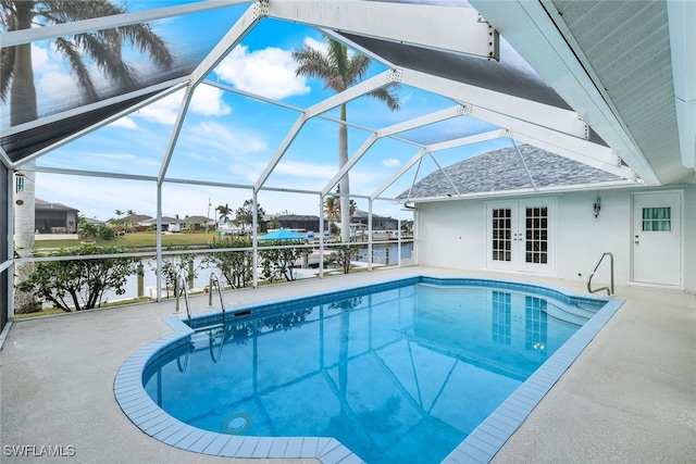 view of swimming pool featuring a water view, a patio, glass enclosure, and french doors