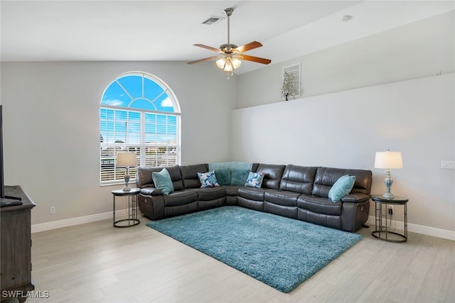 living room with hardwood / wood-style flooring, vaulted ceiling, and ceiling fan