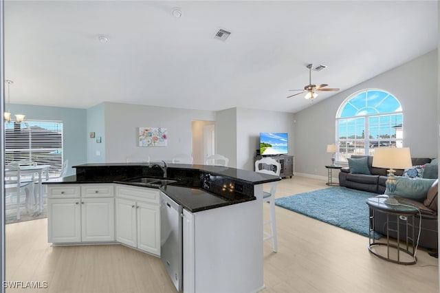 kitchen with sink, white cabinetry, dishwasher, pendant lighting, and a kitchen island with sink