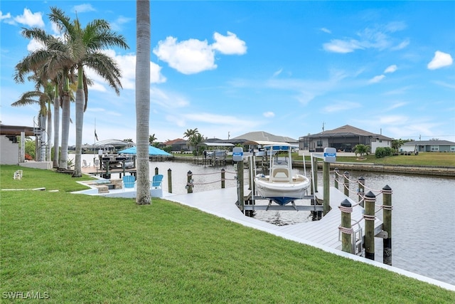 dock area with a water view and a yard