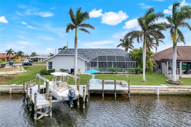 view of dock with a water view, a yard, and a lanai