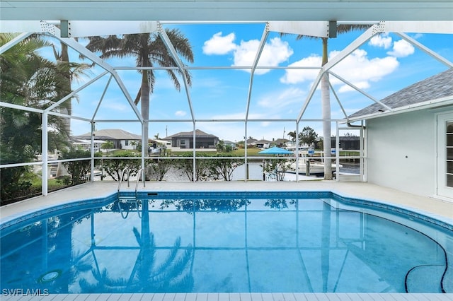 view of pool featuring a water view and glass enclosure