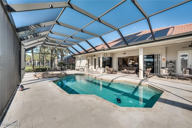 view of pool featuring ceiling fan, a patio area, glass enclosure, and an in ground hot tub