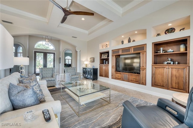 tiled living room featuring built in features, ornamental molding, french doors, and coffered ceiling