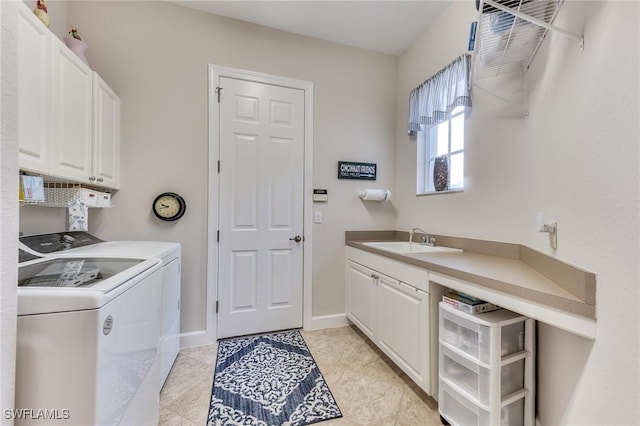 washroom with washing machine and dryer, cabinets, light tile patterned floors, and sink