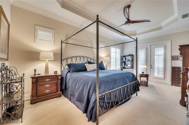 carpeted bedroom featuring ceiling fan, a tray ceiling, access to outside, french doors, and ornamental molding