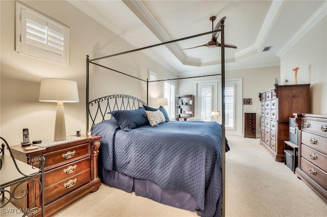 bedroom featuring light colored carpet, crown molding, and a raised ceiling