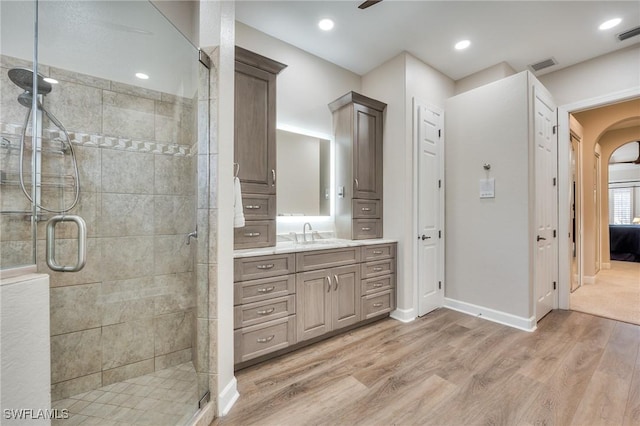 bathroom with vanity, hardwood / wood-style floors, and an enclosed shower