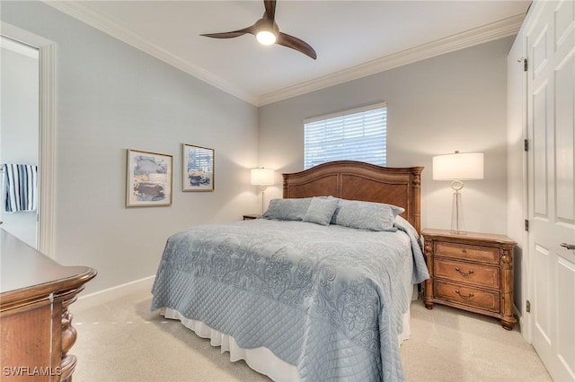 carpeted bedroom featuring ceiling fan and ornamental molding