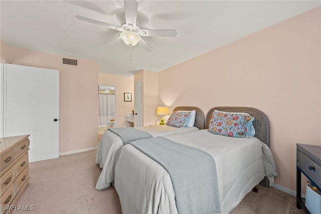 bedroom featuring ceiling fan, light carpet, and connected bathroom